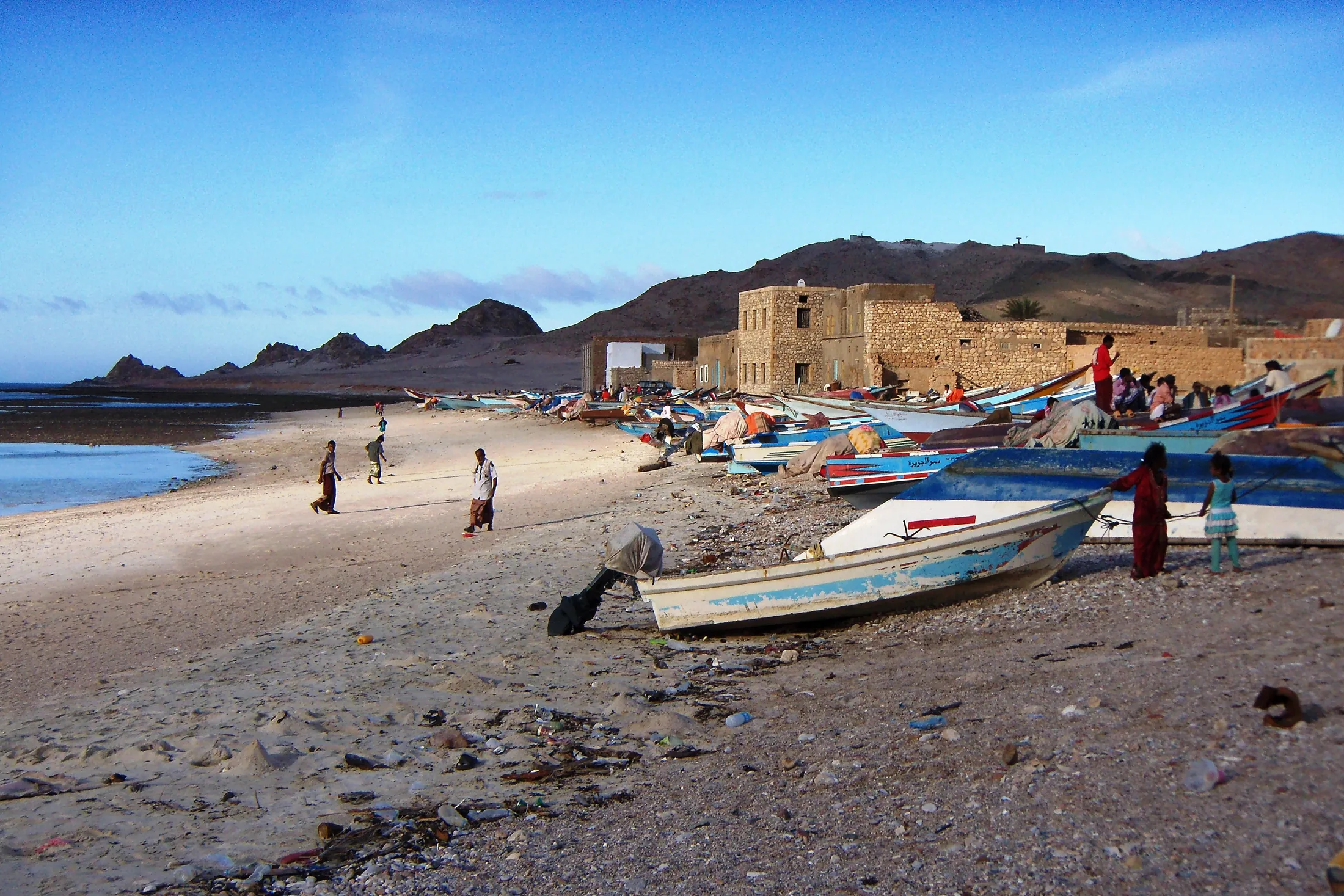 Fishing boats and low buildings along Qalansiyah’s waterfront on Socotra.
